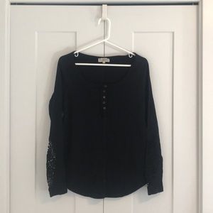 Black long sleeve shirt with lace detail on arms